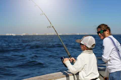 A kid fishes off the Island Pier in Destin-Fort Walton Beach, Florida
