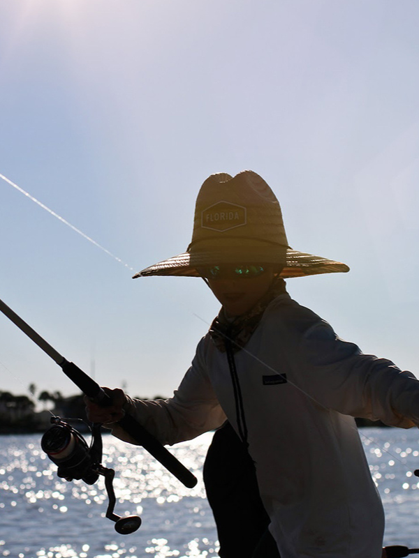 Boy in sun hat fishing