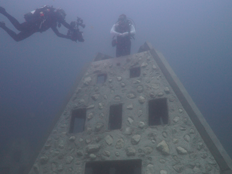 scuba diver underwater near artificial reef