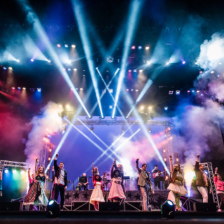 a group of people standing on top of a stage.
