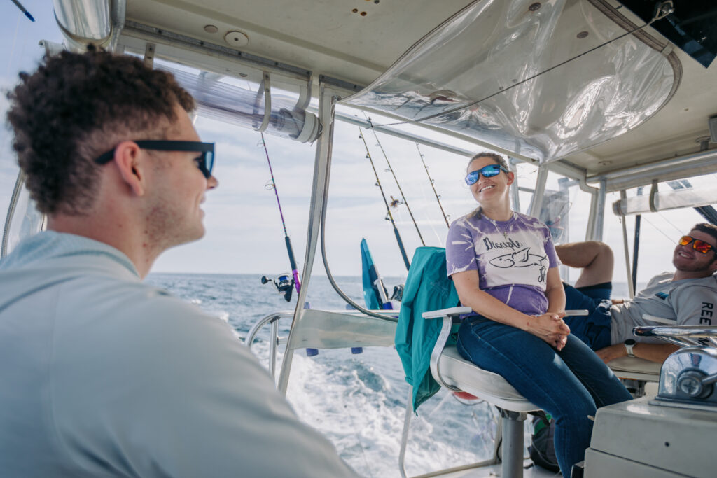 Two people sitting on a boat in the ocean