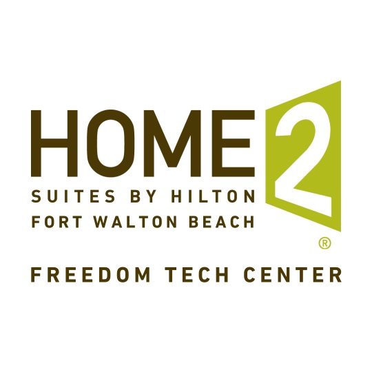 Logo of Home2 Suites by Hilton, Fort Walton Beach, Freedom Tech Center, with text in brown and green.
