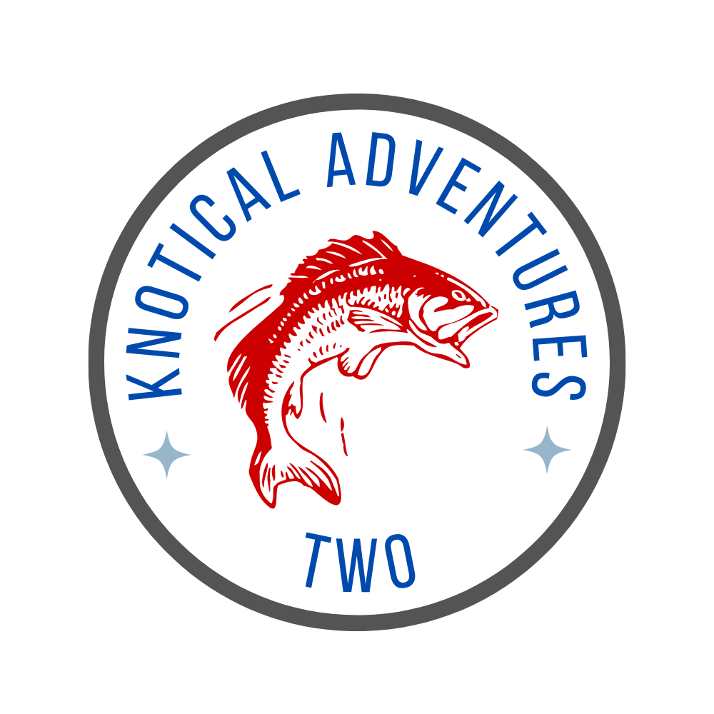 A circular logo with a red fish illustration in the center, blue stars on each side, and the text “Knotical Adventures Two” around the fish.
