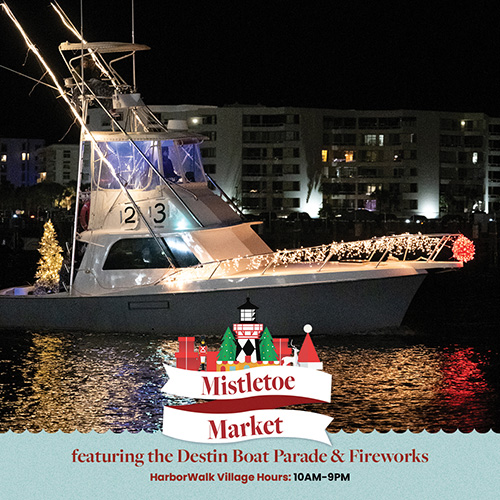 A fishing boat decorated with Christmas lights at night, with text below announcing the Mistletoe Market, Destin Boat Parade, and fireworks.