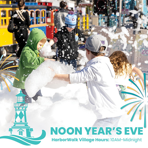 Children play in a foam machine during a Noon Year&rsquo;s Eve event at HarborWalk Village.